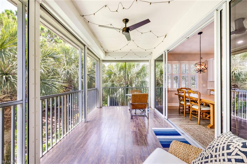 19081 Ridgepoint Drive, Unit 202 Estero, FL 33928 - Photo 28 of 50 a outdoor space with wooden floor and outdoor seating