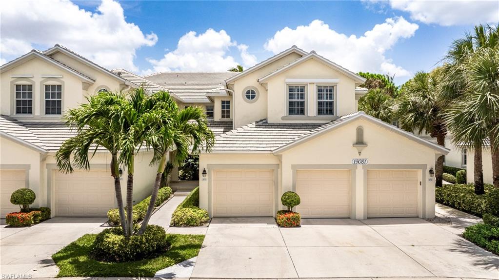 19081 Ridgepoint Drive, Unit 202 Estero, FL 33928 - Photo 32 of 50 a front view of a house with a garden