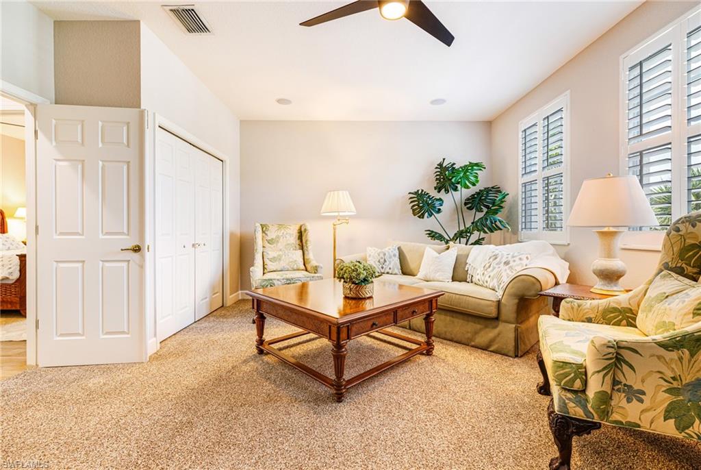 19081 Ridgepoint Drive, Unit 202 Estero, FL 33928 - Photo 10 of 50 a living room with furniture and a potted plant