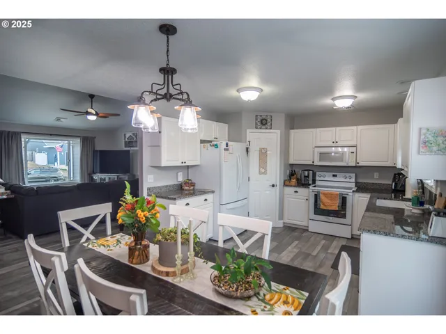 a living room with furniture and kitchen view