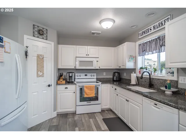 a kitchen with stainless steel appliances a refrigerator sink and cabinets
