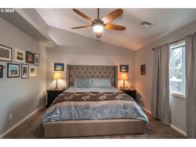 a bedroom with a large bed and a chandelier