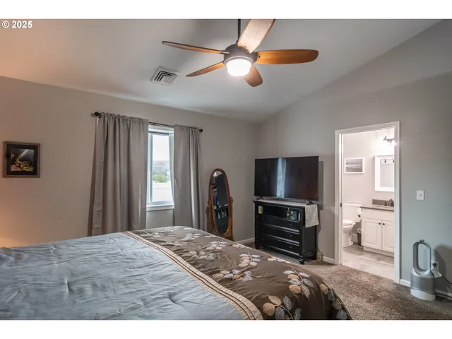 a bedroom with a bed and a television