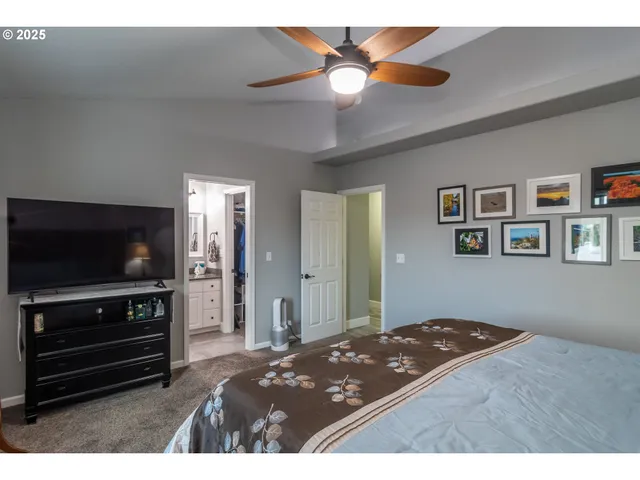 a bedroom with a bed and a flat screen tv
