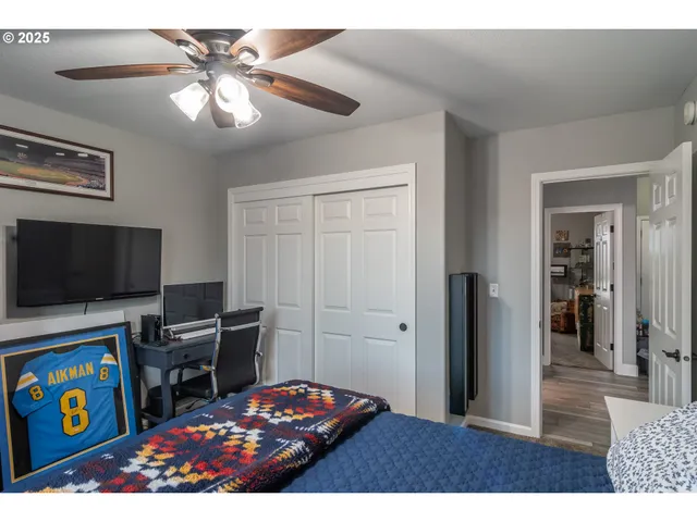 a bedroom with a bed and a flat screen tv