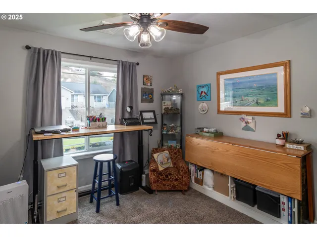 a dining room with wooden floor and large window