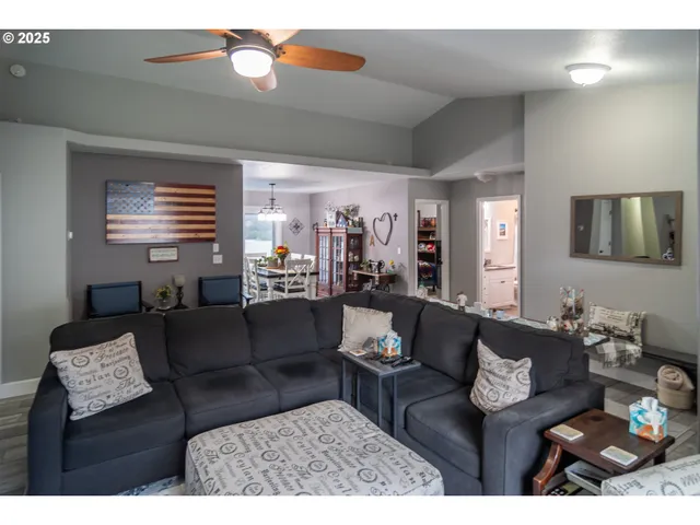 a living room with furniture and a chandelier