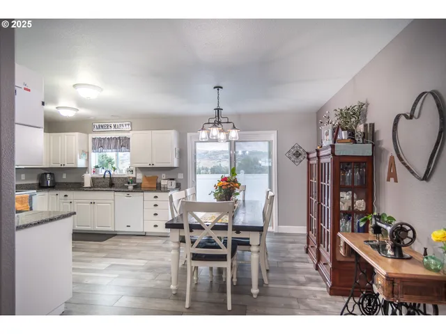a kitchen with stainless steel appliances kitchen island granite countertop a stove and white cabinets