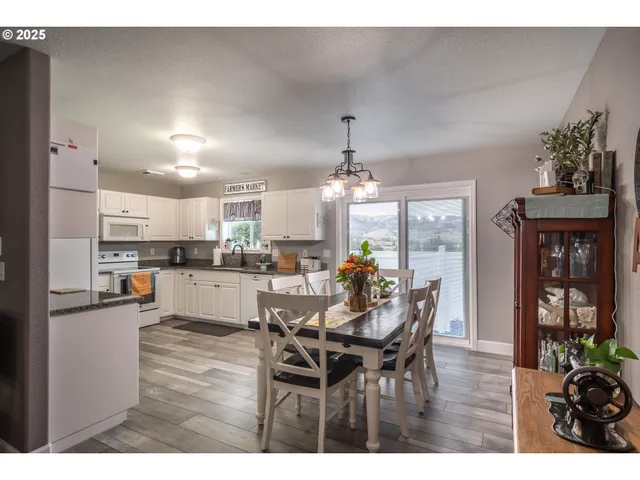 a living room with stainless steel appliances kitchen island granite countertop furniture and a kitchen view