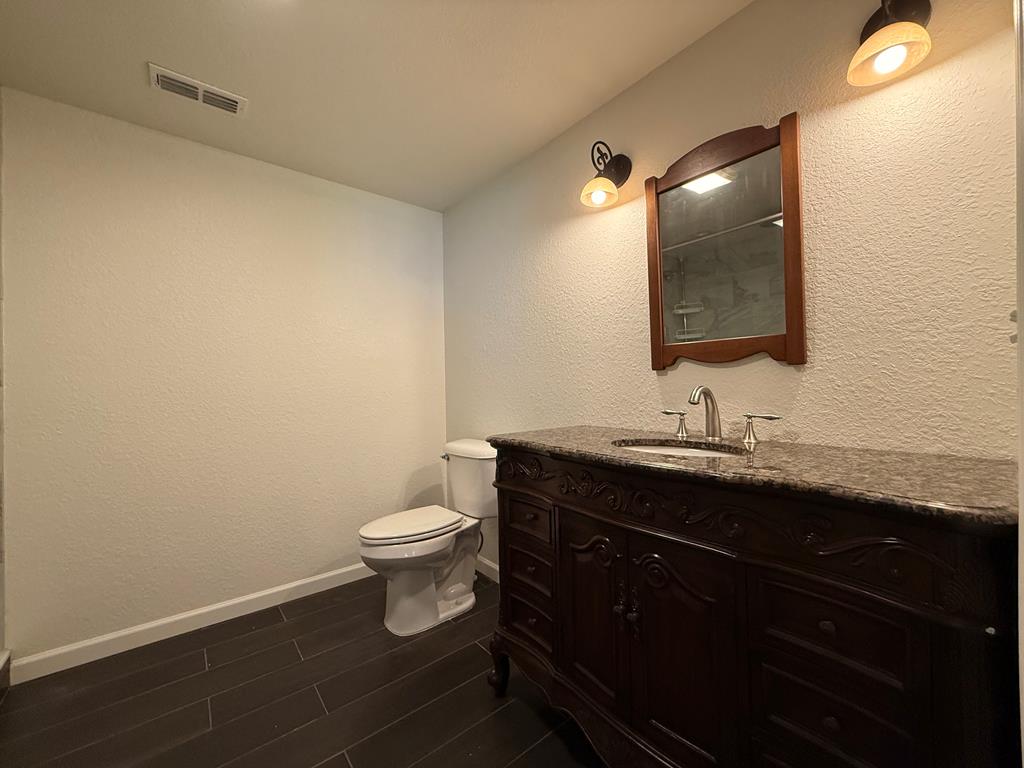 271 Postelle Road Copperhill, TN 37317 - Photo 15 of 59 a bathroom with a granite countertop sink toilet and mirror
