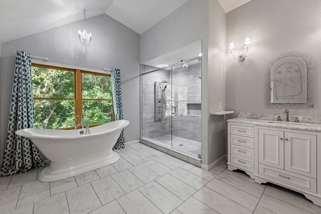 271 Postelle Road Copperhill, TN 37317 - Photo 21 of 59 a spacious bathroom with a double vanity sink a mirror and a bathtub