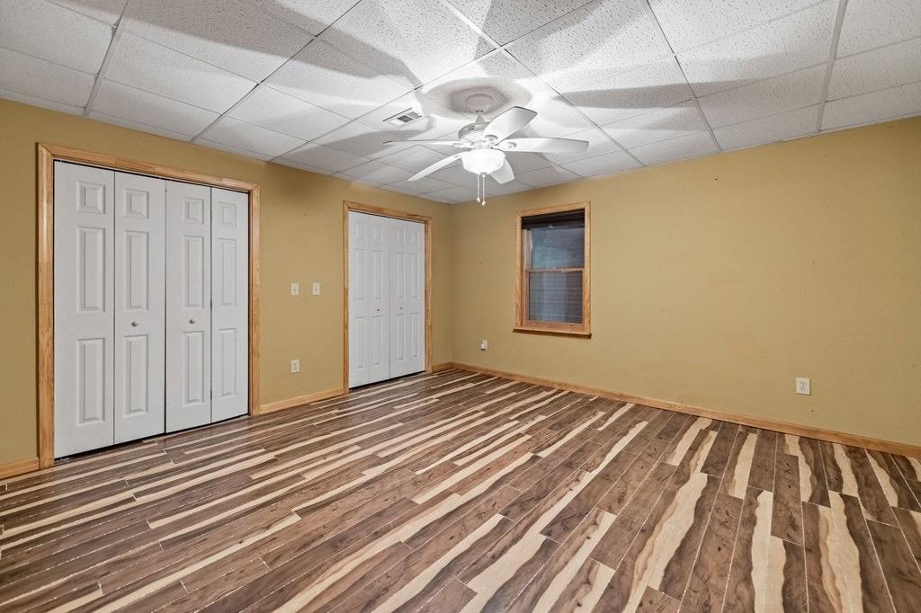 271 Postelle Road Copperhill, TN 37317 - Photo 30 of 59 a view of an empty room with wooden floor and a ceiling fan