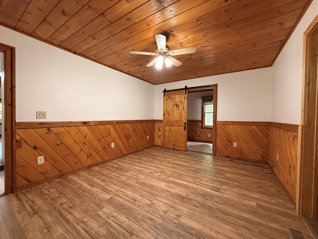 271 Postelle Road Copperhill, TN 37317 - Photo 5 of 59 a view of an empty room with wooden floor and a window