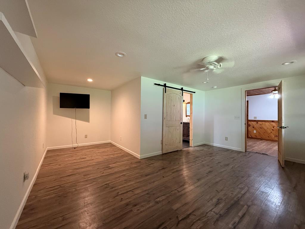271 Postelle Road Copperhill, TN 37317 - Photo 8 of 59 a view of an empty room with wooden floor and a window