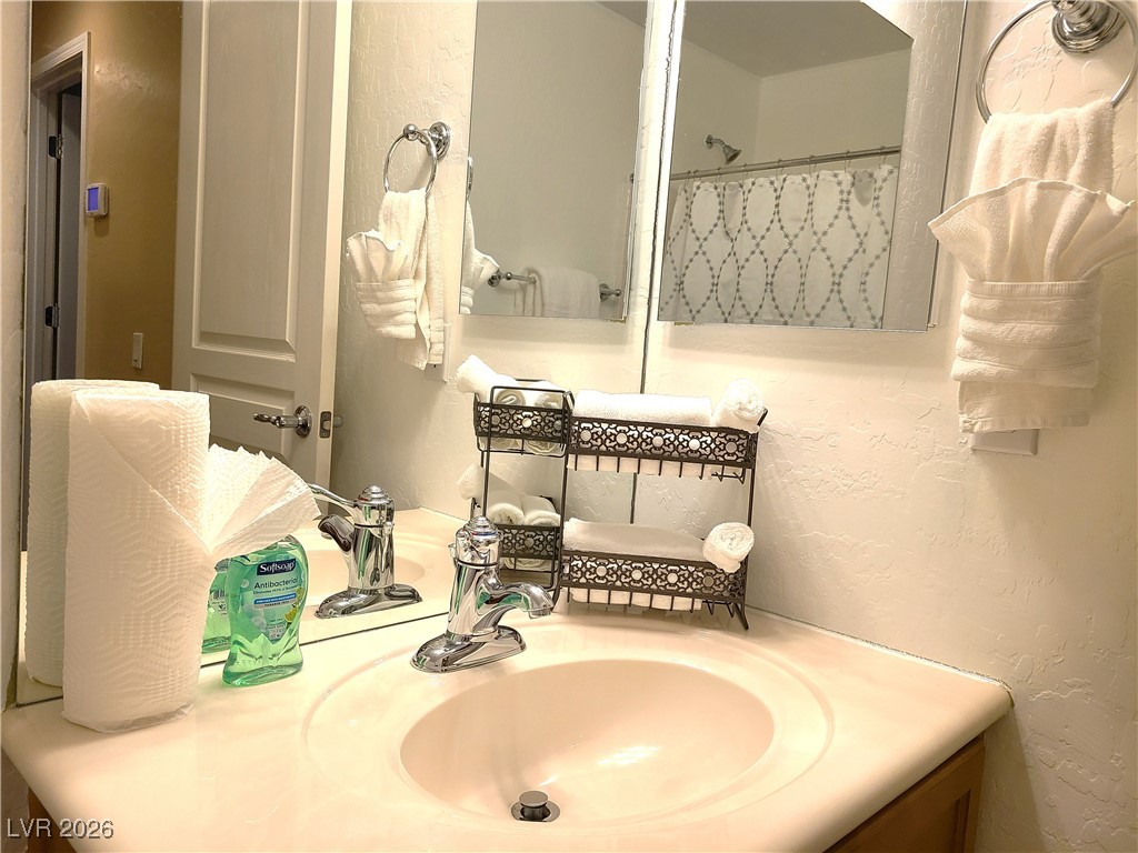 4650 Ranch House Road, Unit 70 North Las Vegas, NV 89031 - Photo 15 of 28 Bathroom with vanity and a textured wall
