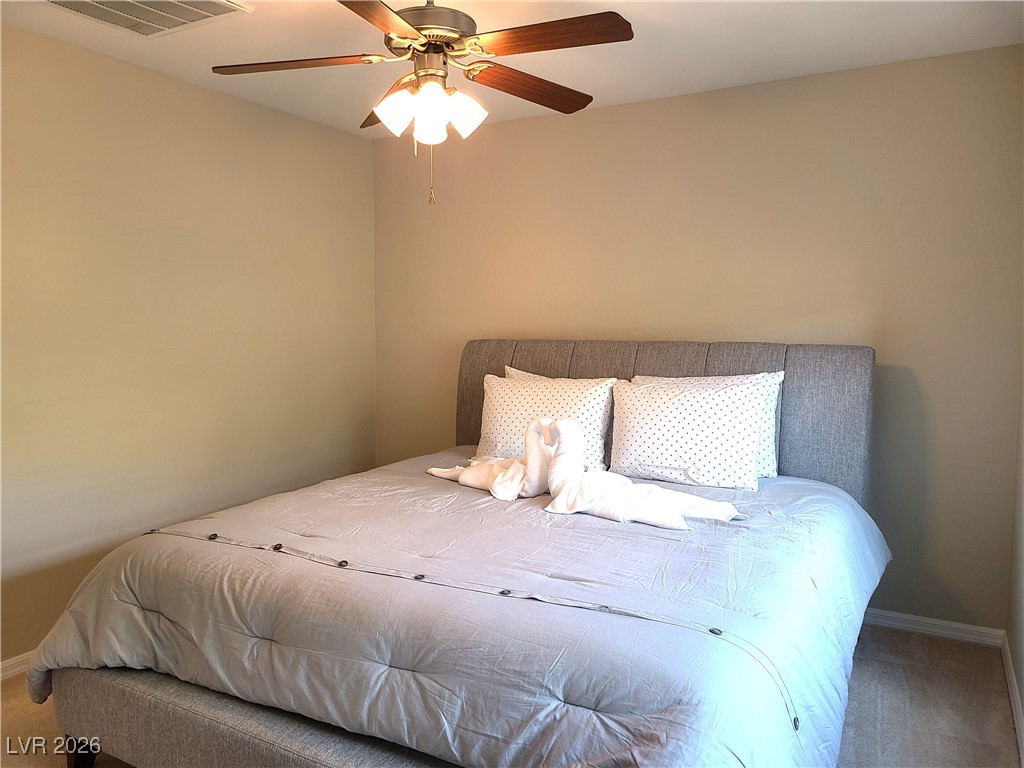 4650 Ranch House Road, Unit 70 North Las Vegas, NV 89031 - Photo 17 of 28 Bedroom with carpet flooring, a ceiling fan, and baseboards