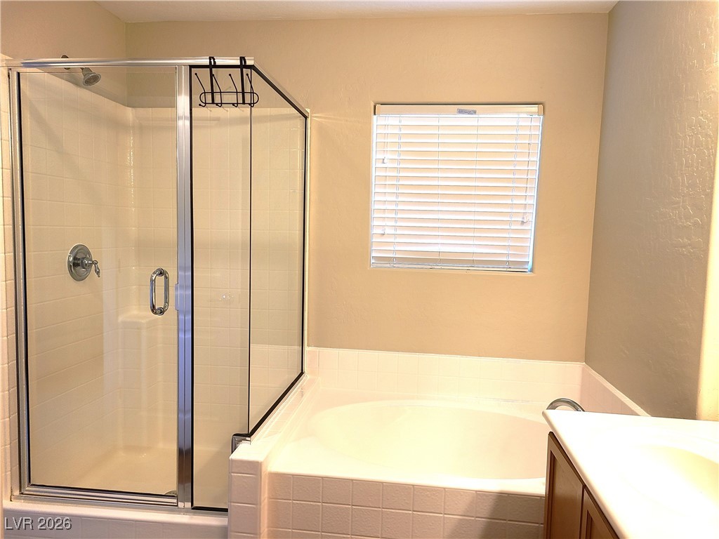 4650 Ranch House Road, Unit 70 North Las Vegas, NV 89031 - Photo 19 of 28 Full bath with a shower stall, a garden tub, and vanity
