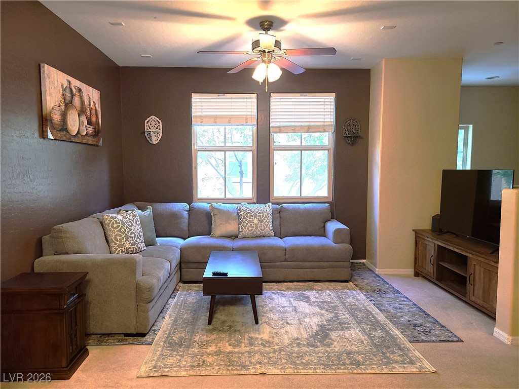 4650 Ranch House Road, Unit 70 North Las Vegas, NV 89031 - Photo 2 of 28 Living area with ceiling fan and light carpet