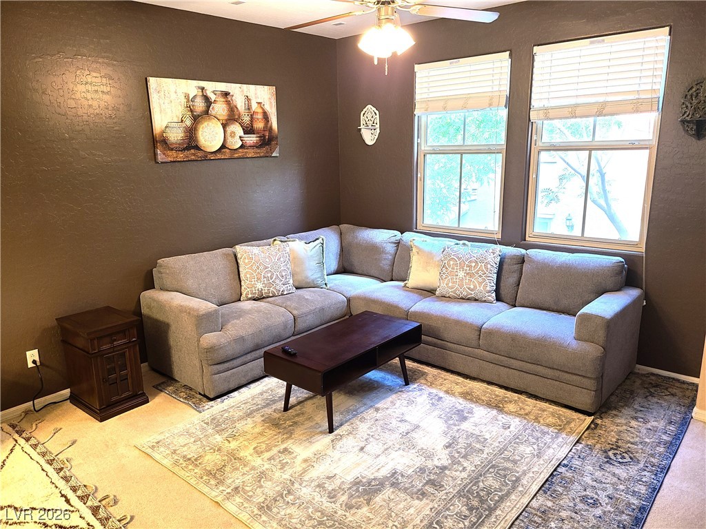 4650 Ranch House Road, Unit 70 North Las Vegas, NV 89031 - Photo 3 of 28 Living room with carpet flooring, ceiling fan, baseboards, and a textured wall