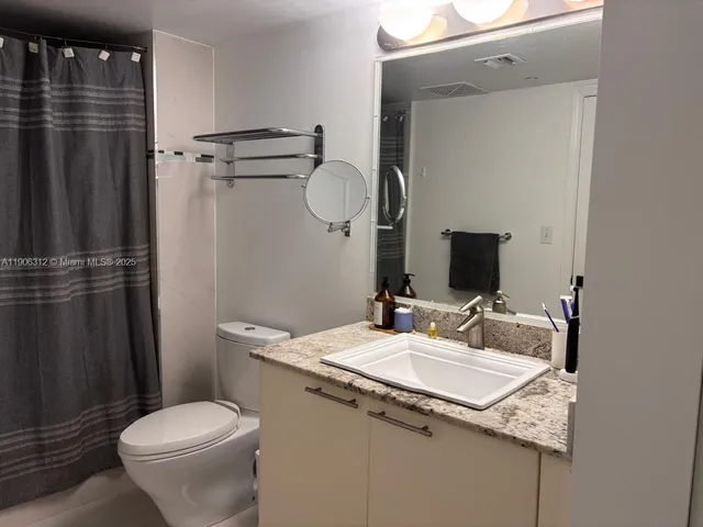a kitchen with a sink and stainless steel appliances