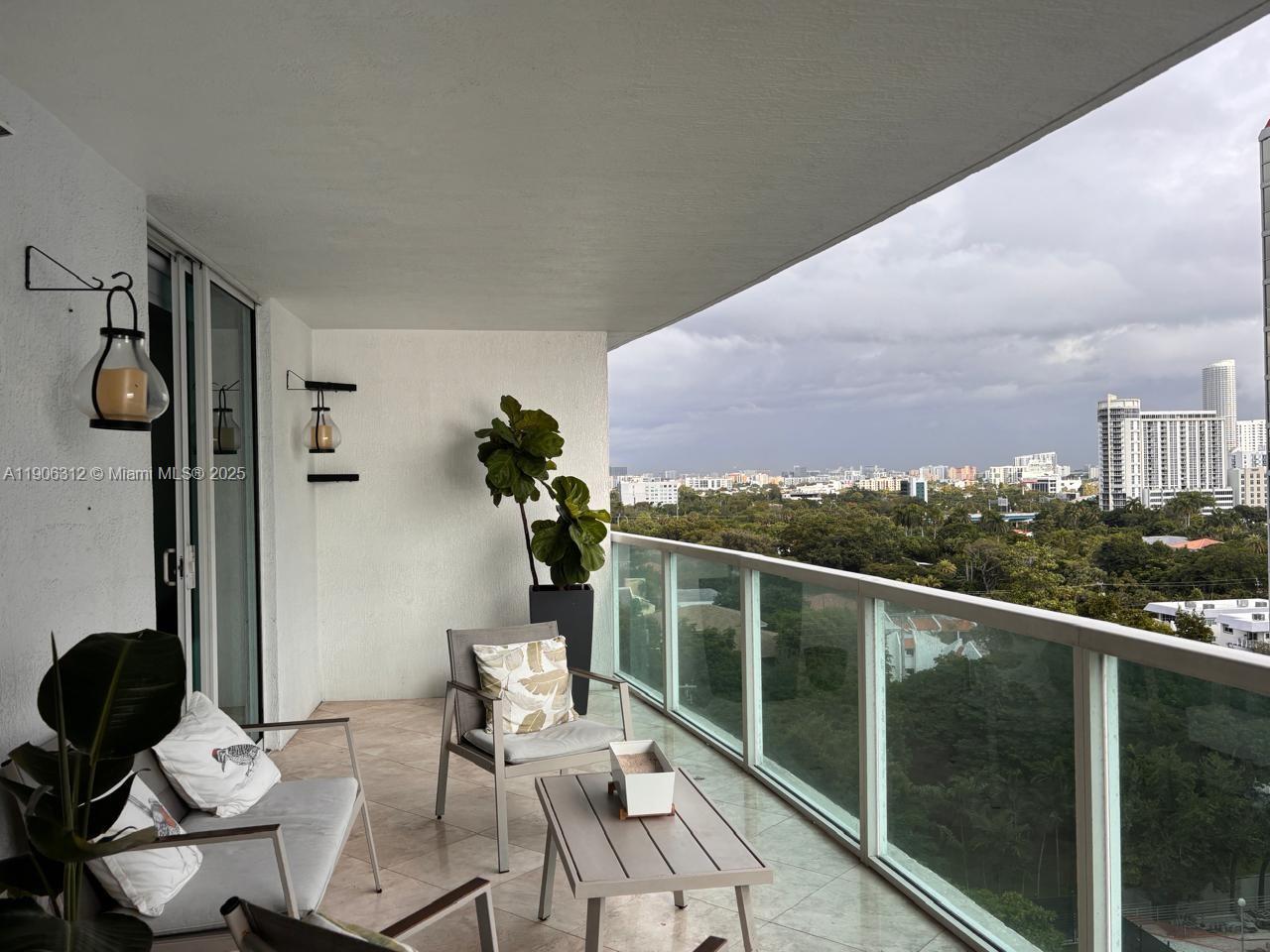 2101 Brickell Avenue, Unit 903 Miami, FL 33129 - Photo 14 of 20 a view of a balcony with chairs and wooden floor