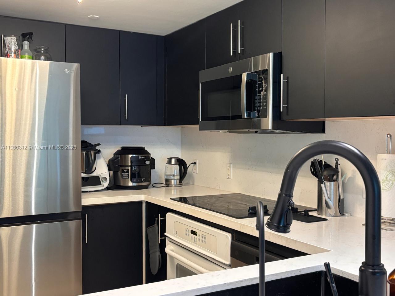 2101 Brickell Avenue, Unit 903 Miami, FL 33129 - Photo 16 of 20 a kitchen with a refrigerator and a sink