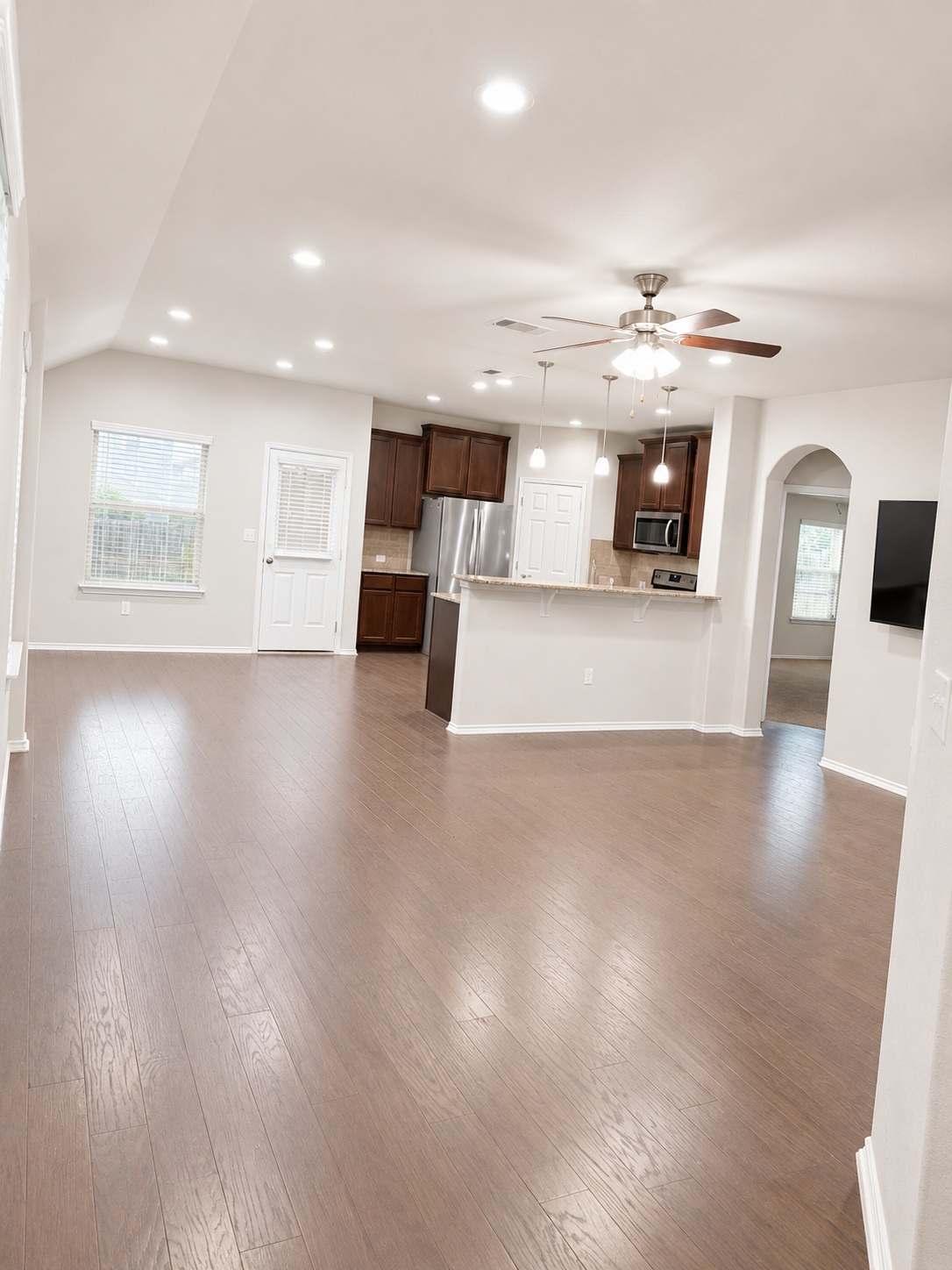 187 Limerick Road Buda, TX 78610 - Photo 3 of 18 An inviting open-concept layout seamlessly connects the kitchen and living spaces, all floored with beautiful hardwood.