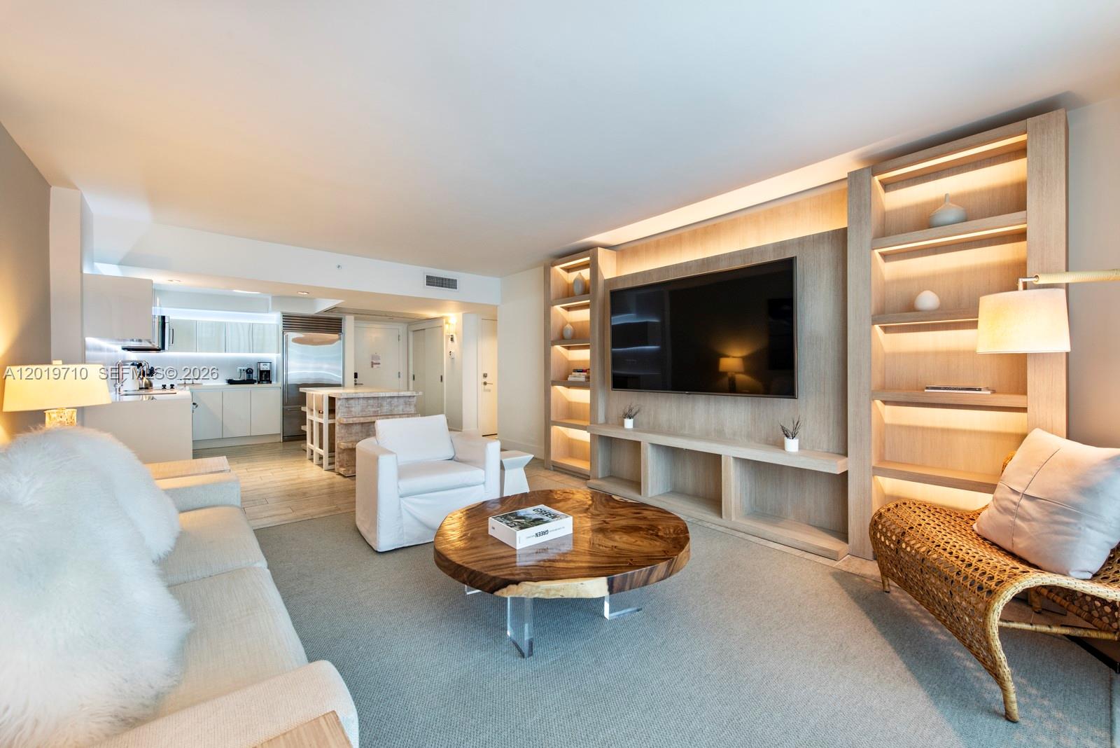 102 24th Street, Unit 1012 Miami Beach, FL 33139 - Photo 1 of 17 a living room with furniture and a flat screen tv