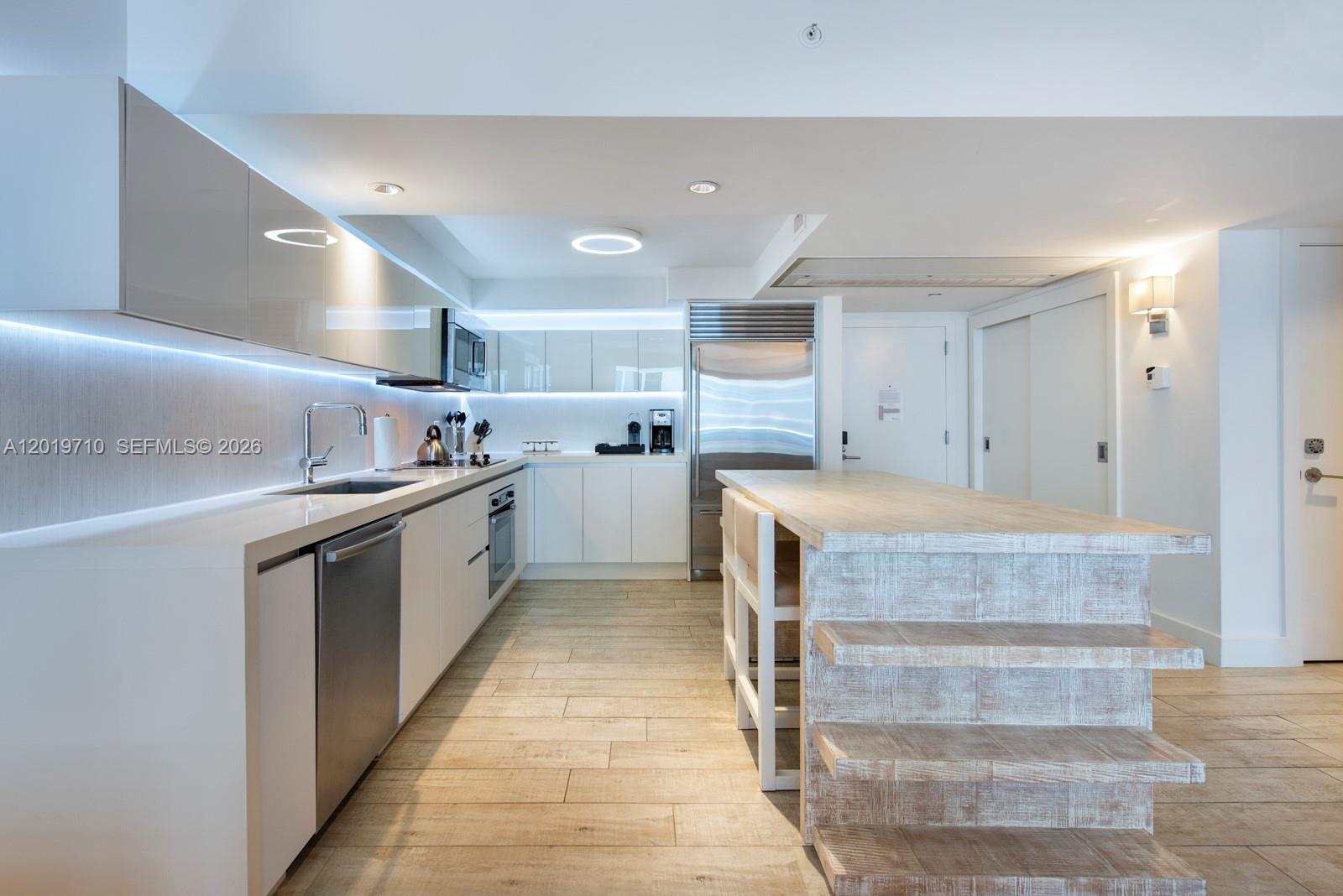 102 24th Street, Unit 1012 Miami Beach, FL 33139 - Photo 14 of 17 a kitchen with granite countertop a sink and cabinets