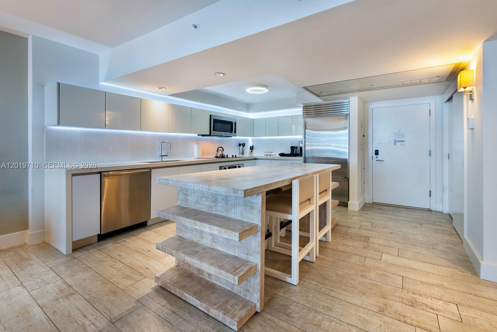 102 24th Street, Unit 1012 Miami Beach, FL 33139 - Photo 5 of 17 a kitchen with stainless steel appliances granite countertop a stove and a refrigerator