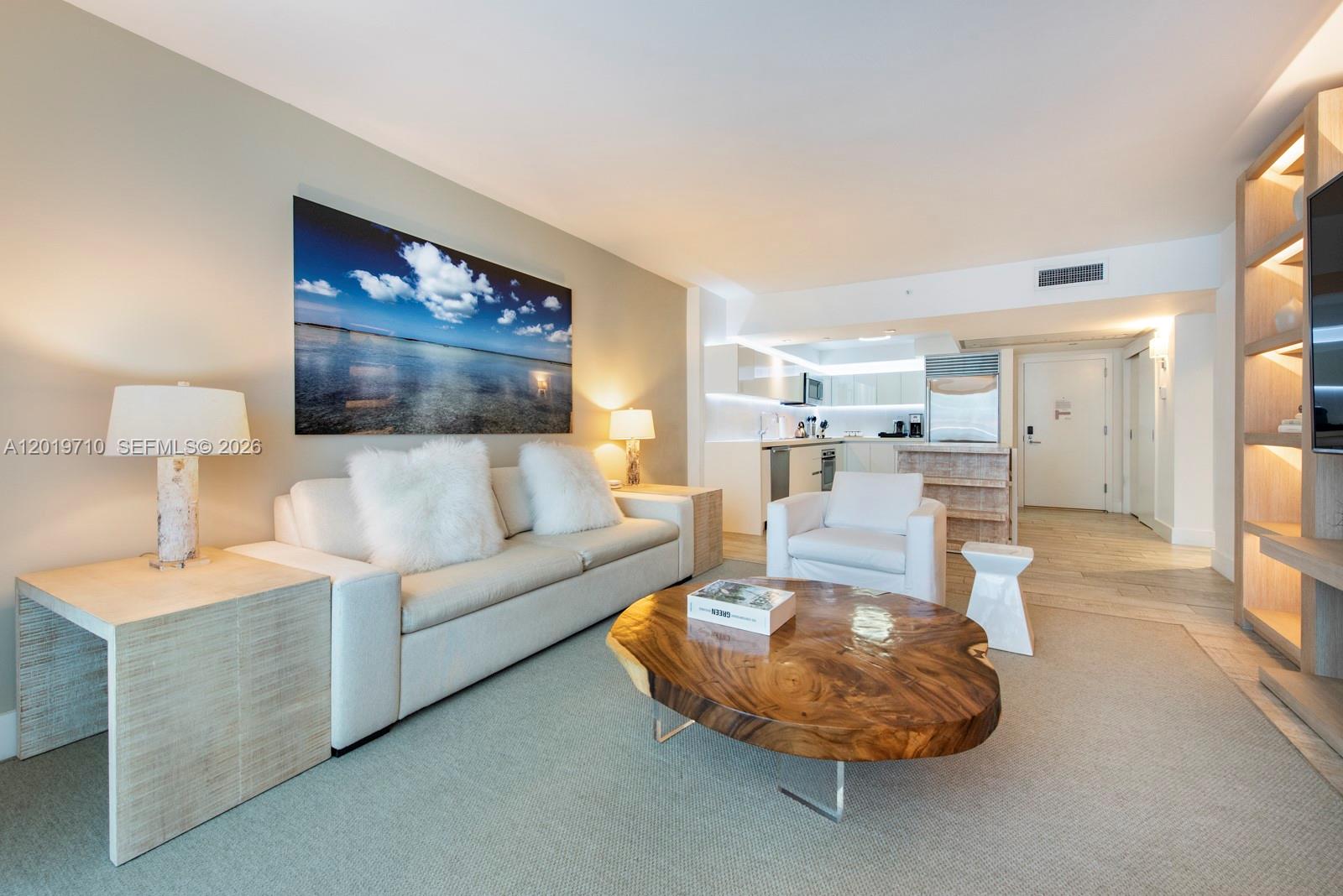 102 24th Street, Unit 1012 Miami Beach, FL 33139 - Photo 10 of 17 a living room with furniture and a lamp