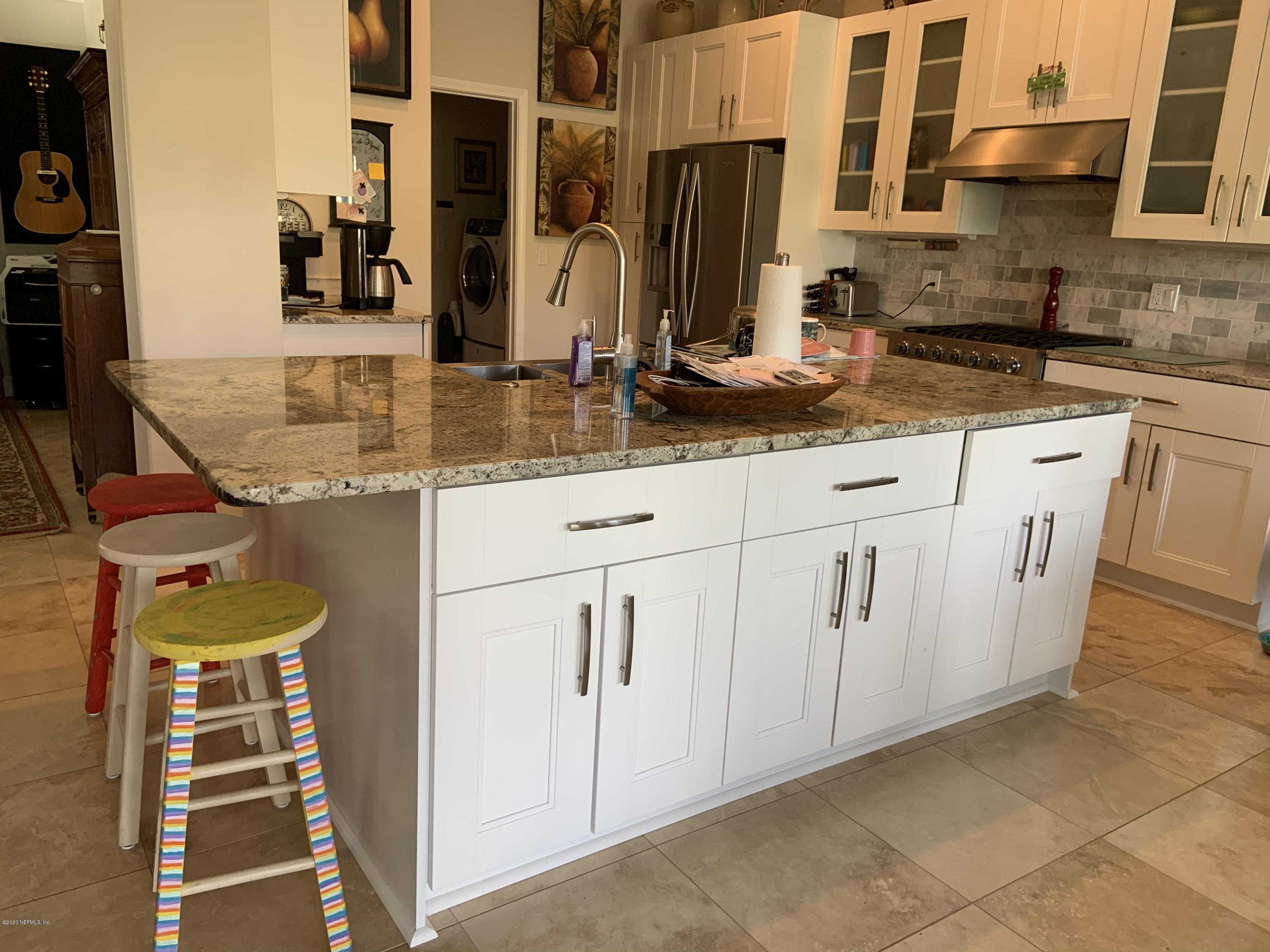 1144 Sandlake Road St. Augustine, FL 32092 - Photo 4 of 11 a kitchen with stainless steel appliances granite countertop a sink and cabinets