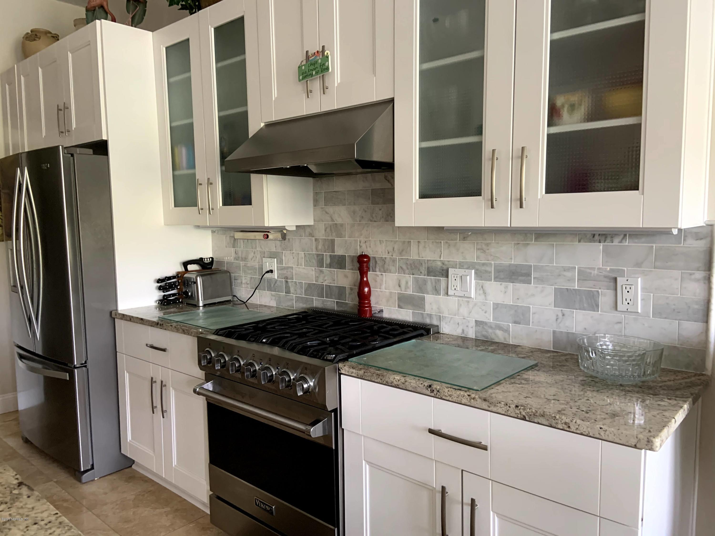 1144 Sandlake Road St. Augustine, FL 32092 - Photo 5 of 11 a kitchen with stainless steel appliances granite countertop a sink stove and refrigerator
