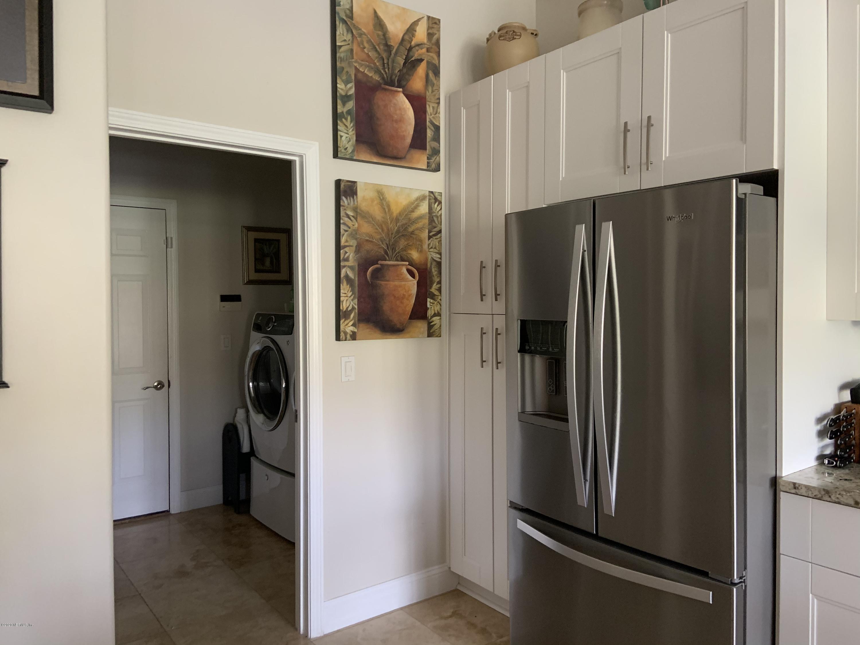 1144 Sandlake Road St. Augustine, FL 32092 - Photo 6 of 11 a metallic refrigerator freezer sitting in a kitchen