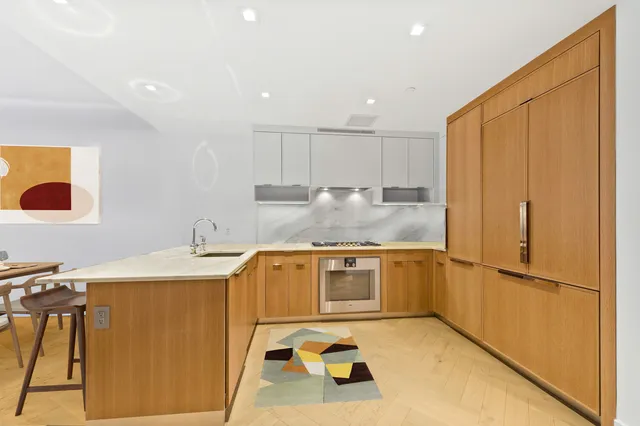 a bedroom with a large bed and a potted plant