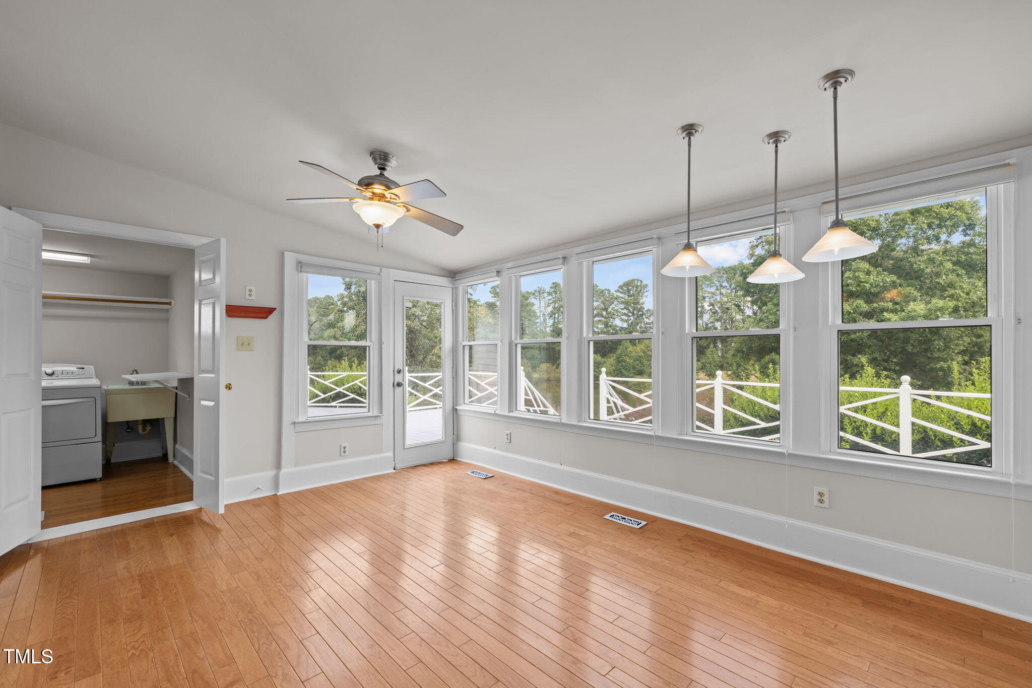 504 Parks Village Road Zebulon, NC 27597 - Photo 19 of 50 a view of an empty room with a window and wooden floor