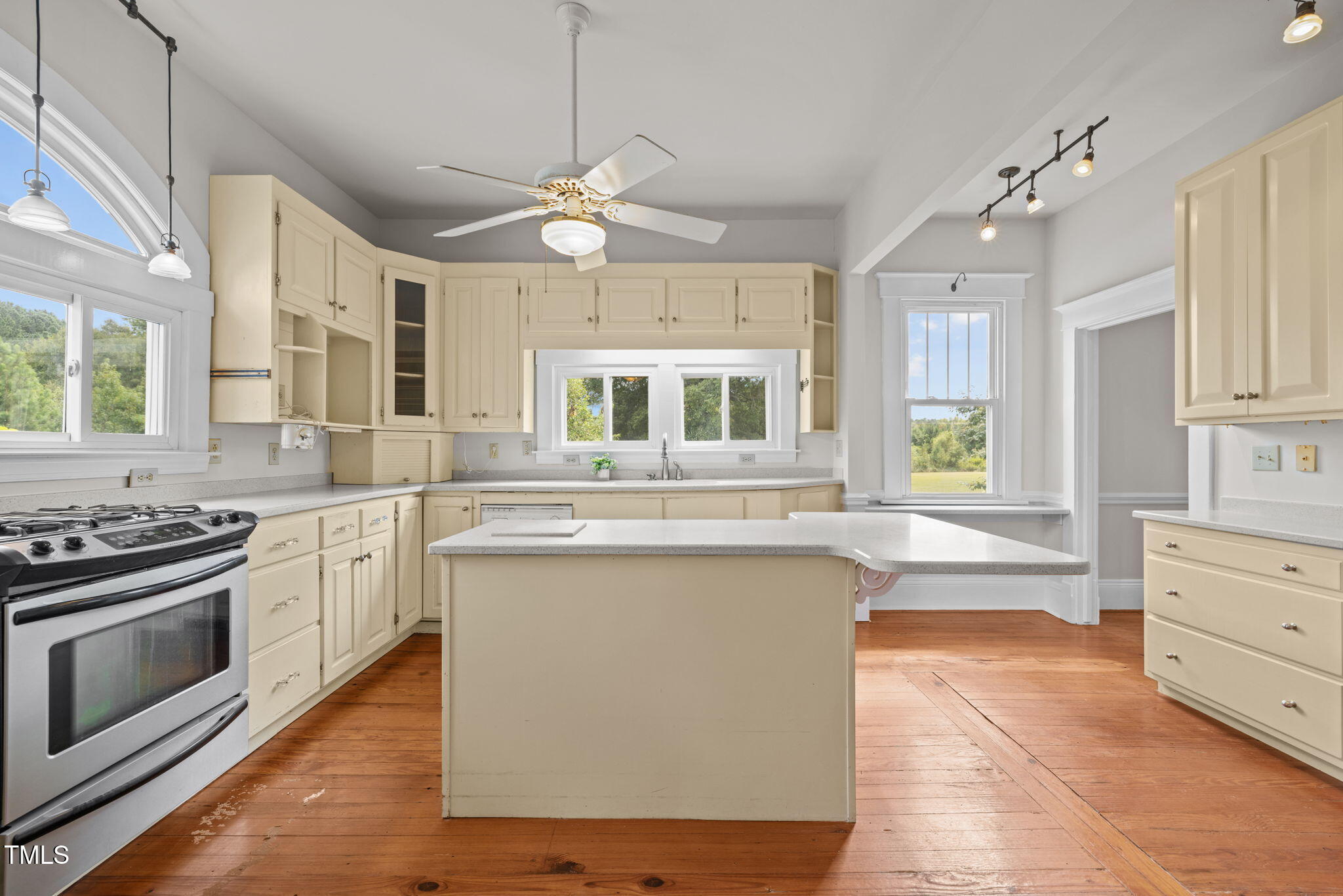 504 Parks Village Road Zebulon, NC 27597 - Photo 10 of 50 a kitchen with stainless steel appliances a stove sink and cabinets