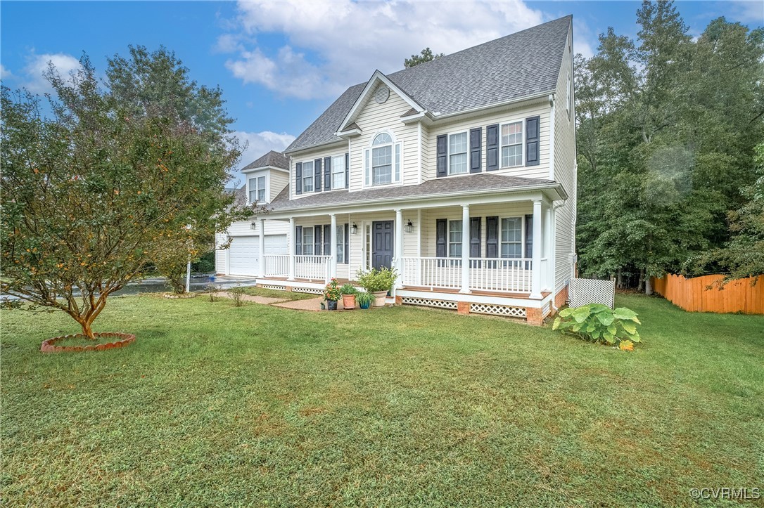 a view of a house with a yard and sitting area