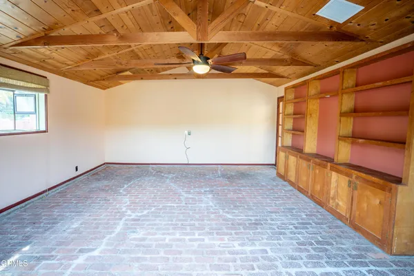 a view of a room with wooden floor and windows