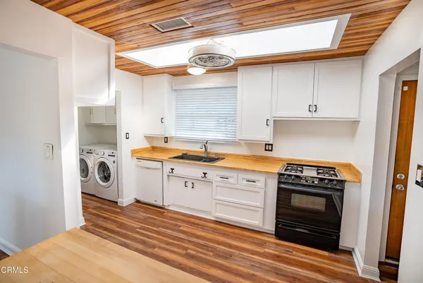 a kitchen with stainless steel appliances granite countertop a stove and a refrigerator