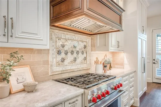 a kitchen with stainless steel appliances granite countertop a stove and a refrigerator