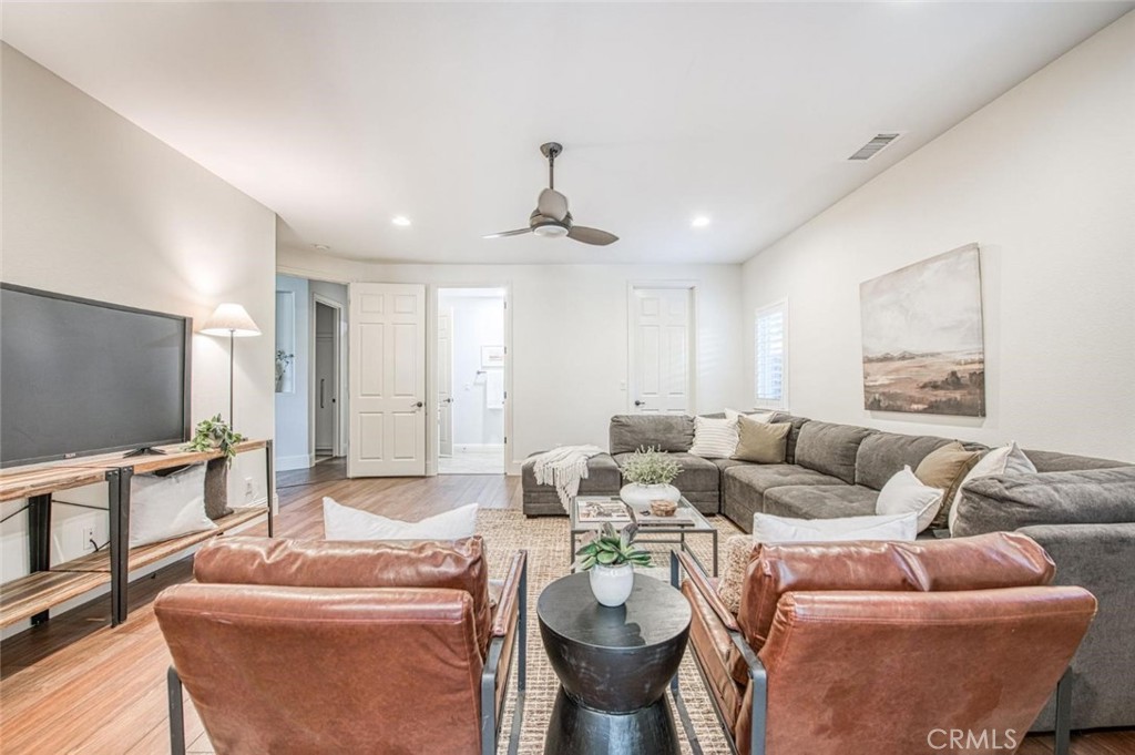 1867 North Rector Avenue Clovis, CA 93619 - Photo 21 of 49 a living room with furniture a chandelier and a flat screen tv
