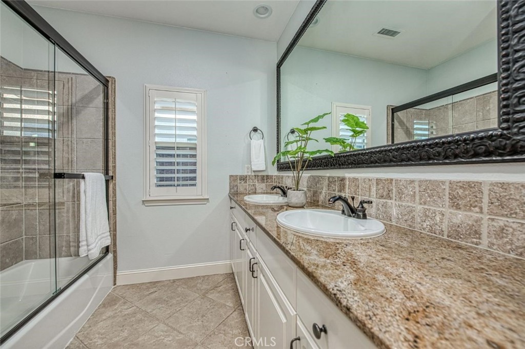 1867 North Rector Avenue Clovis, CA 93619 - Photo 27 of 49 a bathroom with a granite countertop sink a mirror and shower