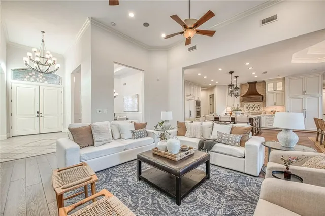 a living room with furniture ceiling fan and a rug