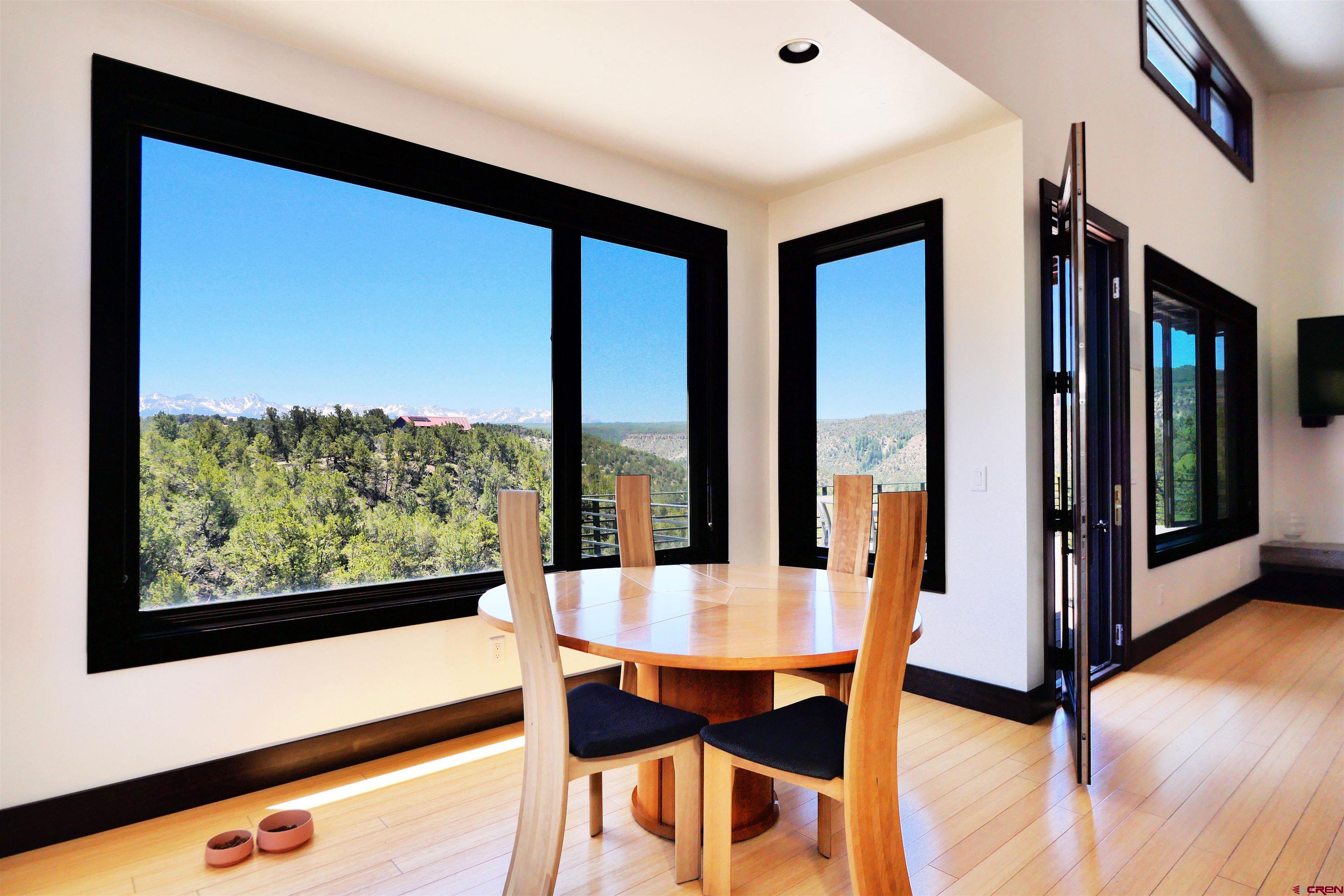 456 Ridge Road Montrose, CO 81403 - Photo 9 of 24 a view of a city from a dining room with large windows