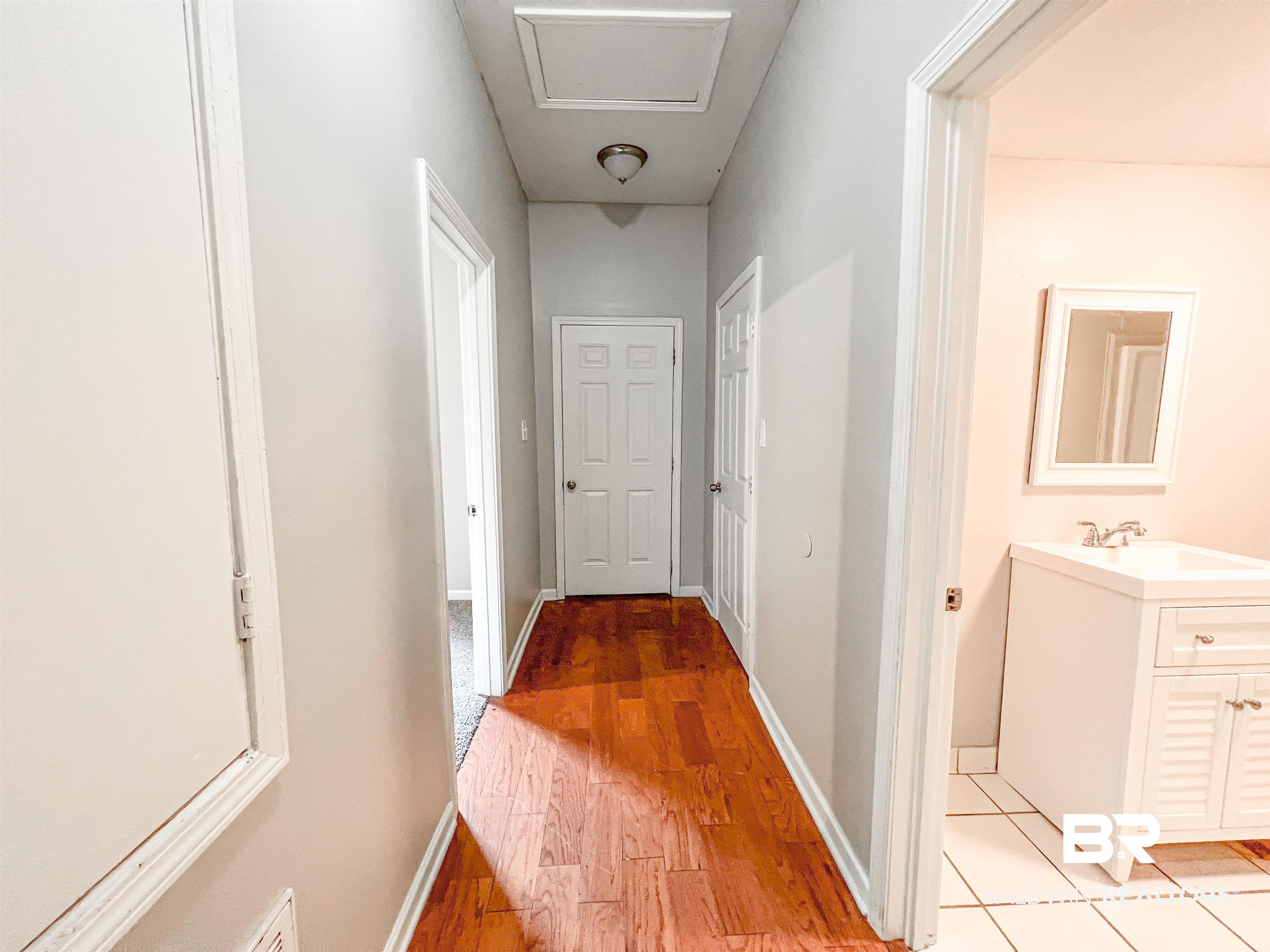 1164 Seneca Street Mobile, AL 36605 - Photo 13 of 22 Hallway featuring baseboards, a sink, and light wood finished floors