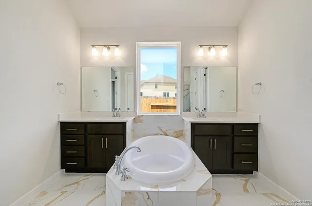 a bathroom with a sink vanity and mirror