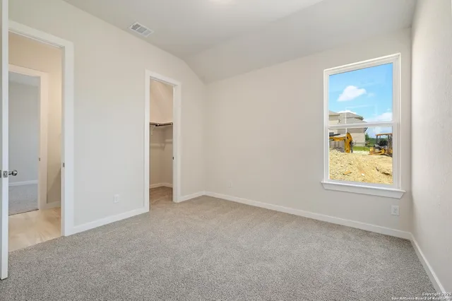 an empty room with windows and closet