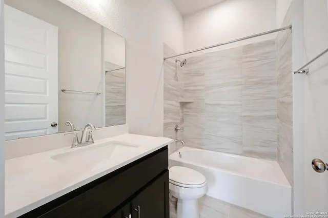 a bathroom with a sink a toilet and bathtub