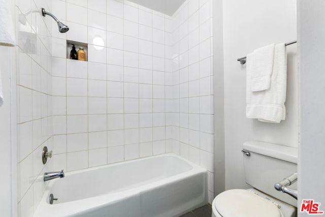 a bathroom with a bathtub and toilet